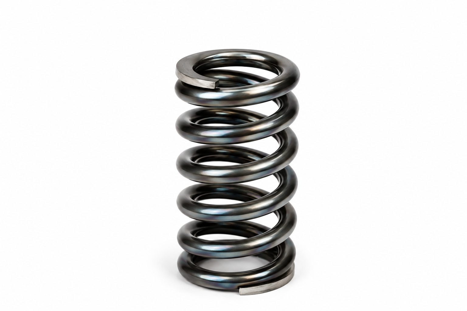 Helical compression spring in bright spring steel showing the ground ends and coil geometry used to explain fatigue, buckling, spring surge and compression spring design.